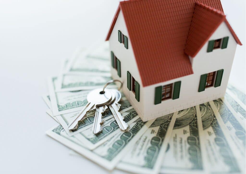 Keys, money, and a house representing closing costs for buyers and sellers in Southern Maryland.
