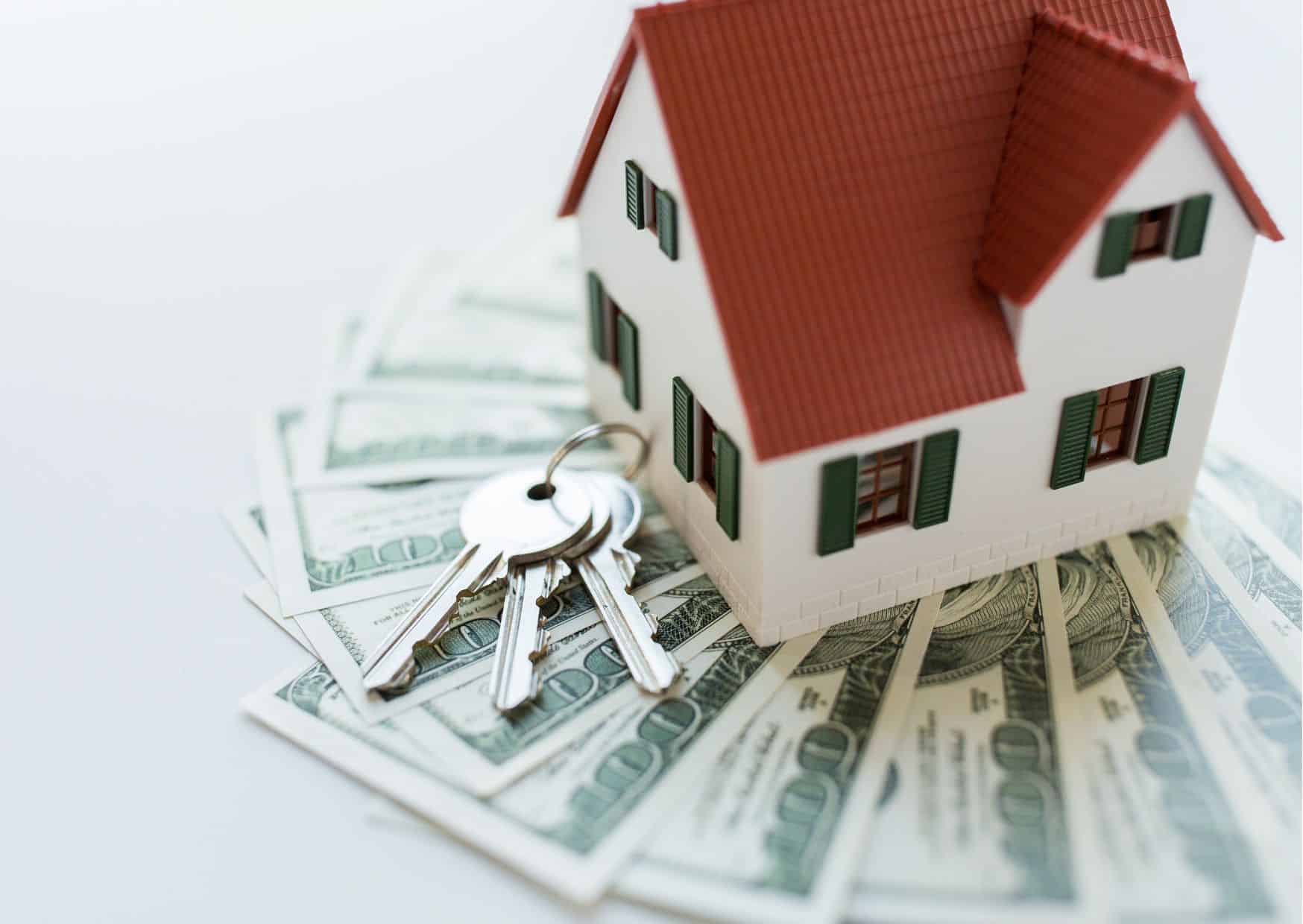 Keys, money, and a house representing closing costs for buyers and sellers in Southern Maryland.